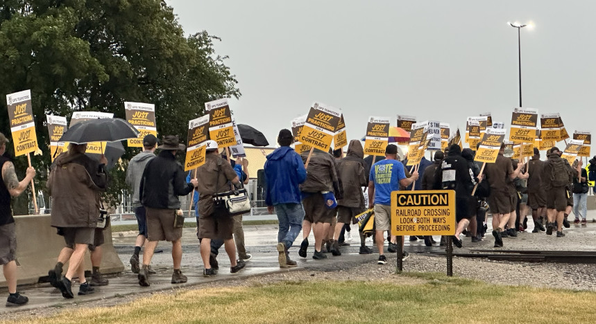 UPS Teamsters Local 90 Crosses the railroad track during their practice picket